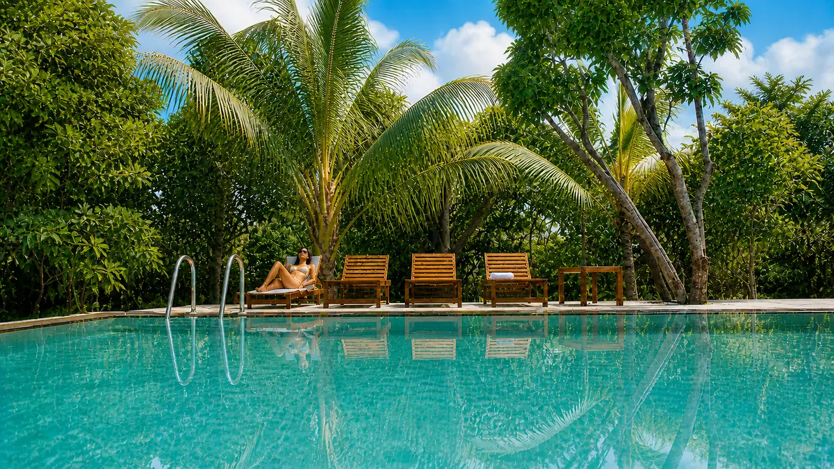 The swimming pool at Manike Lodge framed by tropical trees